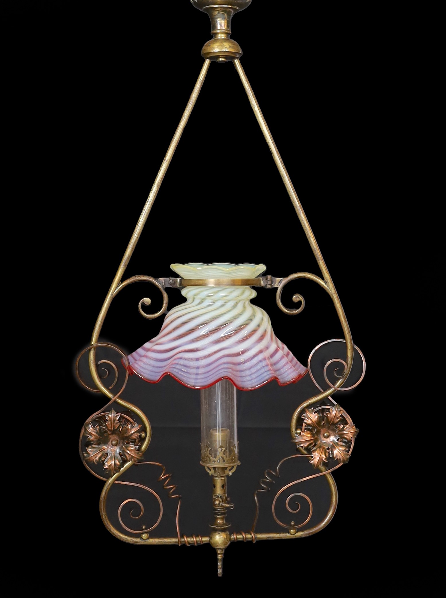 An English Arts & Crafts lacquered brass and copper gasolier with red tinted Vaseline glass shade, height 80cm. width 40cm